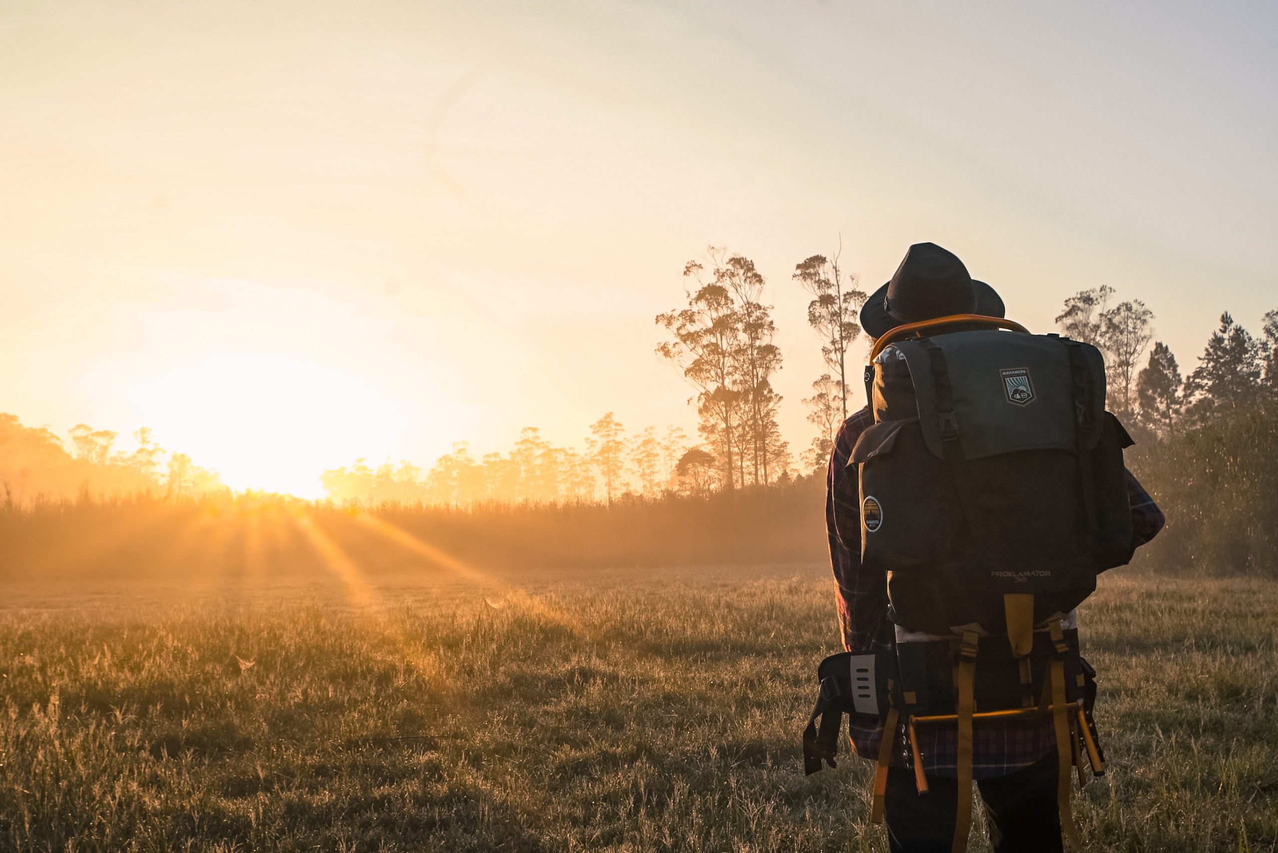 man-in-black-backpack-during-golden-hour-1230302